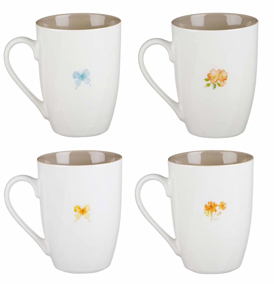 Set of four white mugs with floral designs on a white background