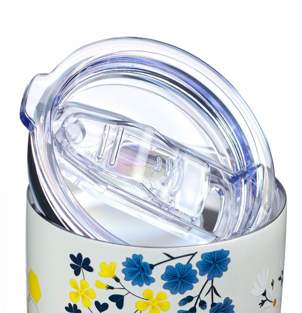 Tumbler with floral design and clear lid on a white background