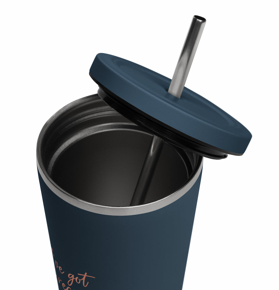 Navy blue tumbler with a straw on a white background