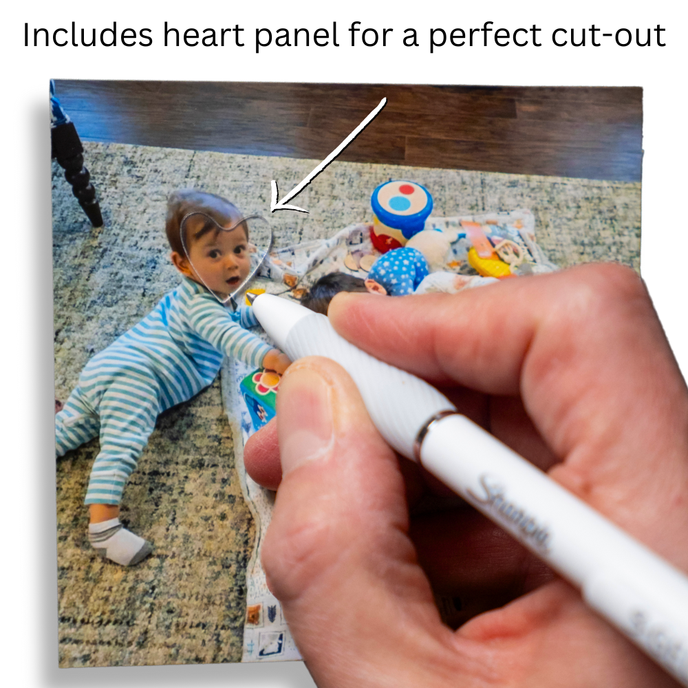 Hand holding a marker over a photo of a baby with text about a heart panel for cut-out.