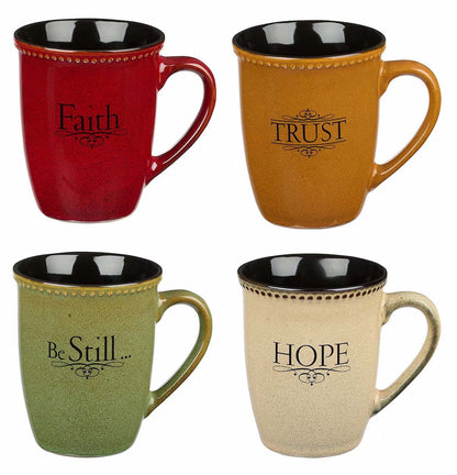 A set of four stoneware mugs in different colors, each with a spiritual word: Faith, Hope, Trust, and Be Still, written on it.