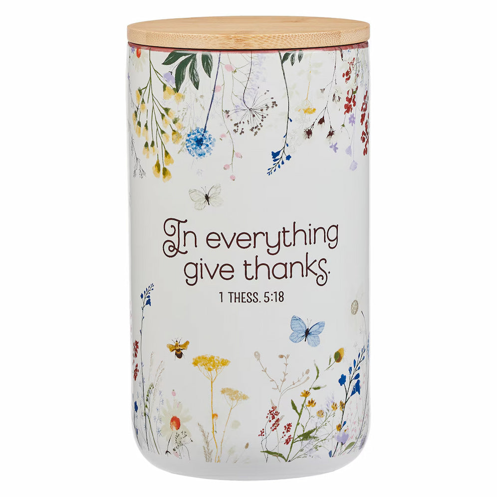 Decorative storage jar with floral designs and motivational quote on a white background