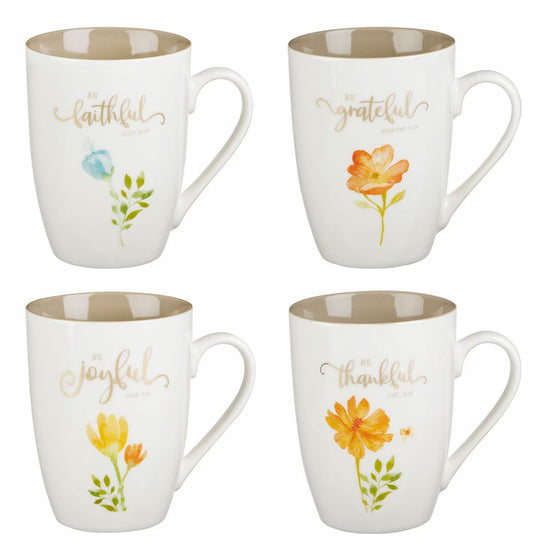 Four mugs with floral designs and text on a white background