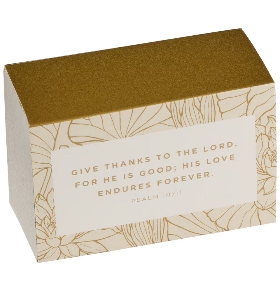 Box with gold text and floral design on a white background