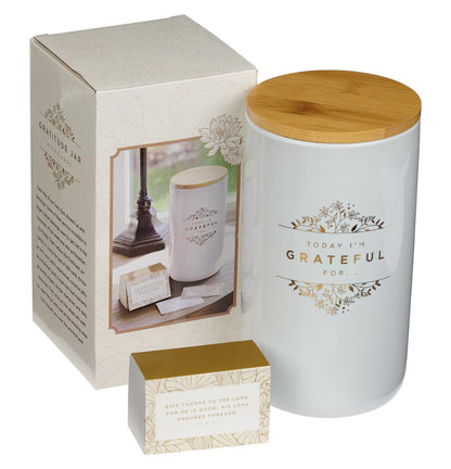 White jar with wooden lid and 'Today I'm Grateful' text, alongside packaging on a white background