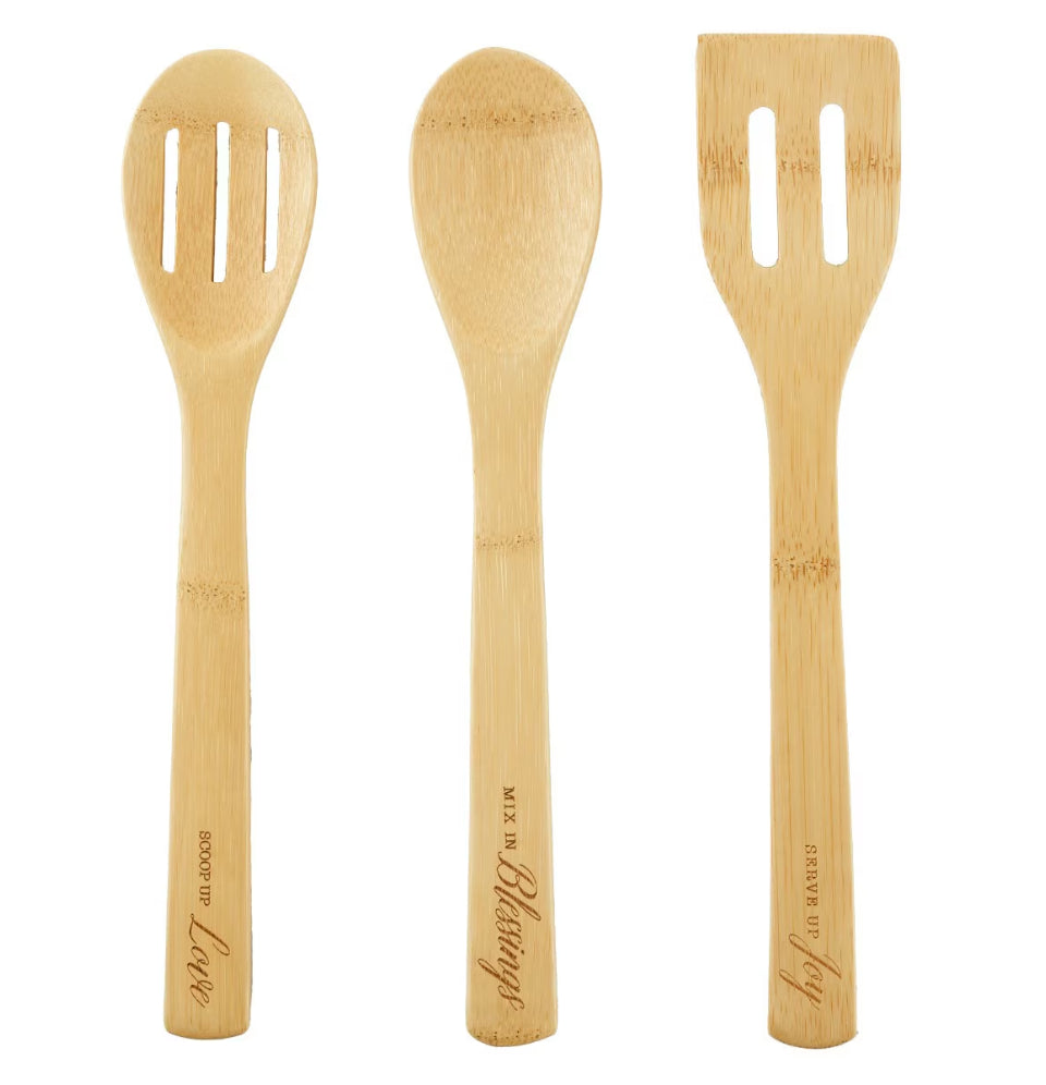 Three wooden utensils with slots on a white background